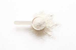 Spoonful of white powder on a white background