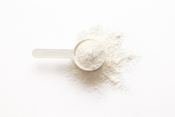 Spoonful of white powder on a white background